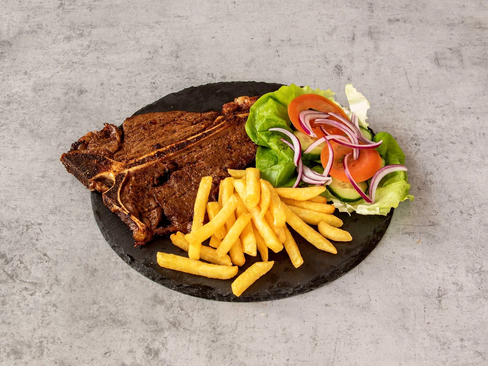 T-Bone steak, chips and salad